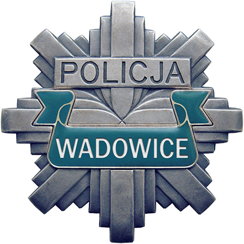 Odznaka policyjna koloru szarego z napisem Policja Wadowice.