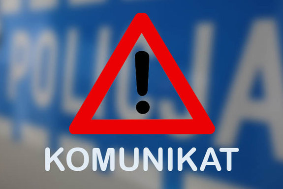 Czerwony trójkąt wewnątrz którego jest czarny wykrzyknik. Poniżej biały napis Komunikat