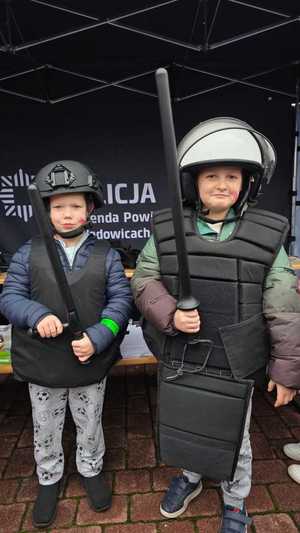 Dwóch chłopców ubranych w elementy umundurowania policyjnego