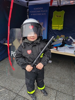 Mały chłopiec ubrany w elementy policyjnego umundurowania