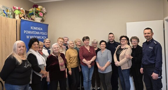 Grupa kobiet i dwóch umundurowanych policjantów