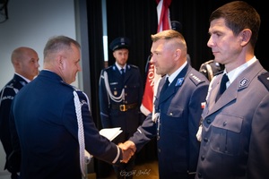 Komendant Wojewódzki wręczający akt mianowania policjantowi